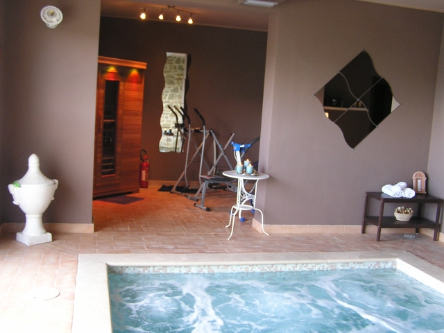 The inside pool with jacuzzi and the sauna